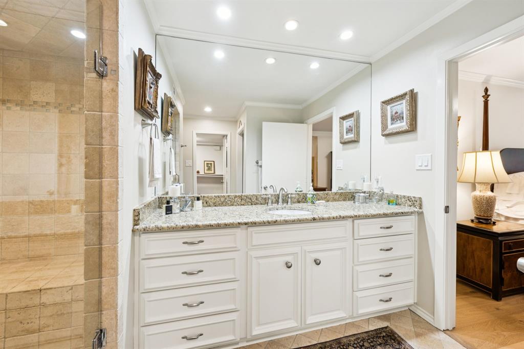 6227 Bandera Avenue, Unit D Dallas, TX 75225 - Photo 12 of 16 a bathroom with a granite countertop sink mirror and