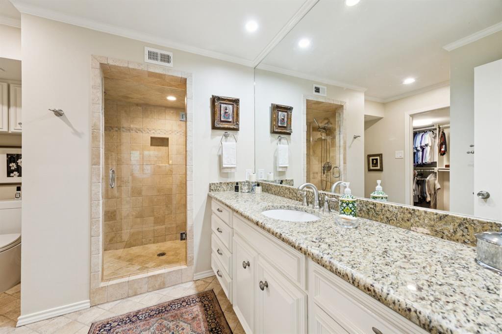 6227 Bandera Avenue, Unit D Dallas, TX 75225 - Photo 13 of 16 a bathroom with a granite countertop sink mirror and shower