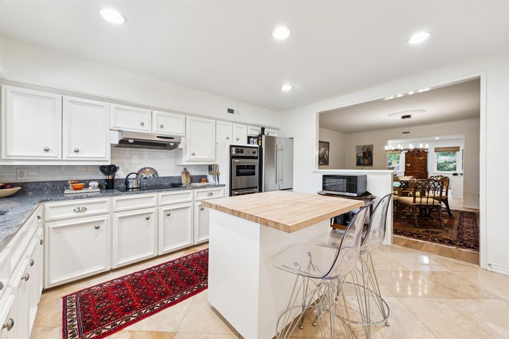 6227 Bandera Avenue, Unit D Dallas, TX 75225 - Photo 6 of 16 a kitchen with stainless steel appliances kitchen island granite countertop a sink and cabinets