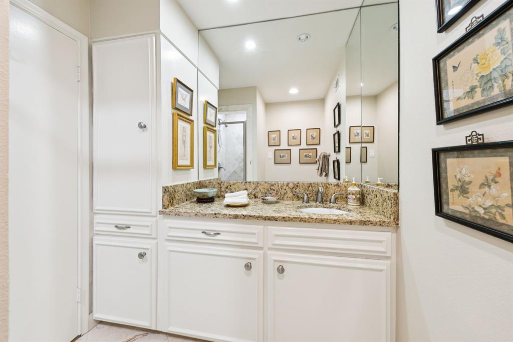 6227 Bandera Avenue, Unit D Dallas, TX 75225 - Photo 10 of 16 a bathroom with a granite countertop sink and a mirror