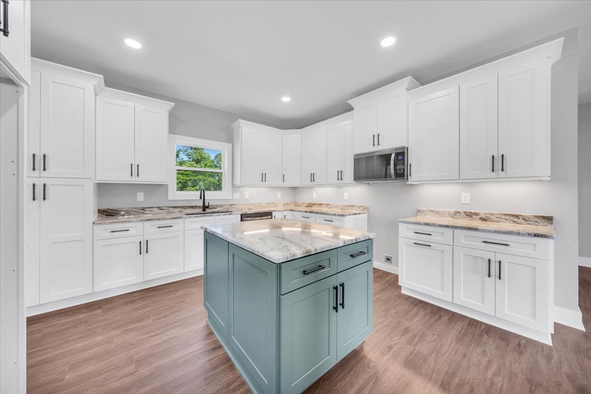 101 Brinkley Road Wartrace, TN 37183 - Photo 8 of 39 a kitchen with granite countertop white cabinets and white appliances