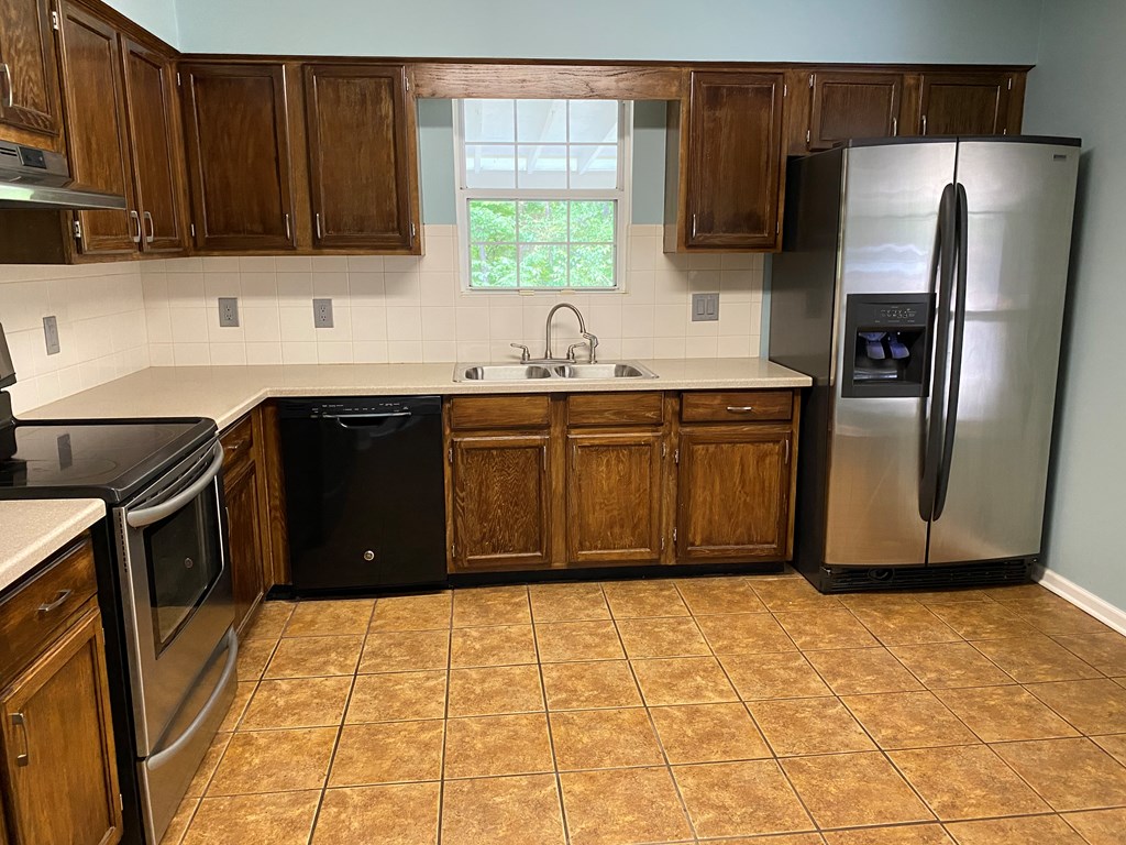 501 Hardy Road LaGrange, GA 30241 - Photo 23 of 37 a kitchen with stainless steel appliances granite countertop a refrigerator and a sink