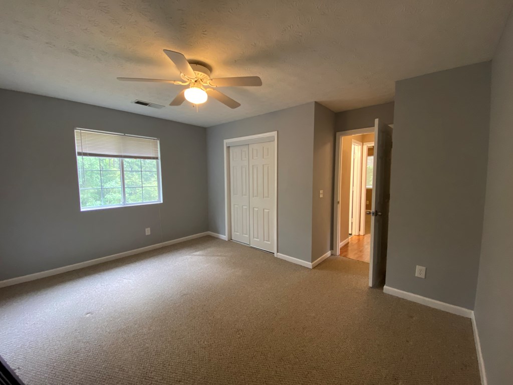 501 Hardy Road LaGrange, GA 30241 - Photo 27 of 37 an empty room with windows and a ceiling fan