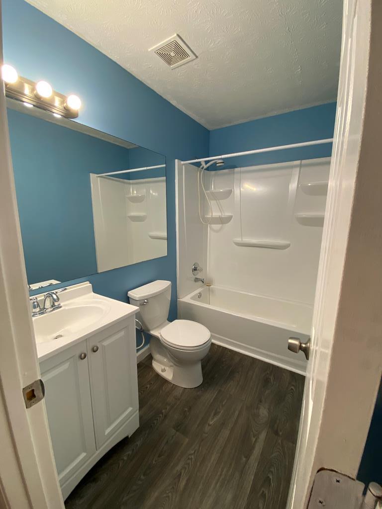 501 Hardy Road LaGrange, GA 30241 - Photo 29 of 37 a bathroom with a granite countertop toilet a sink and a mirror