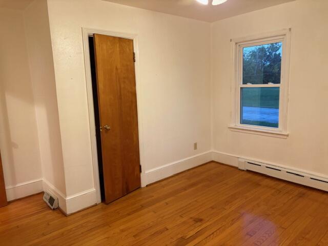 2356 West Riverside Drive Salem, VA 24153 - Photo 9 of 22 an empty room with wooden floor and windows