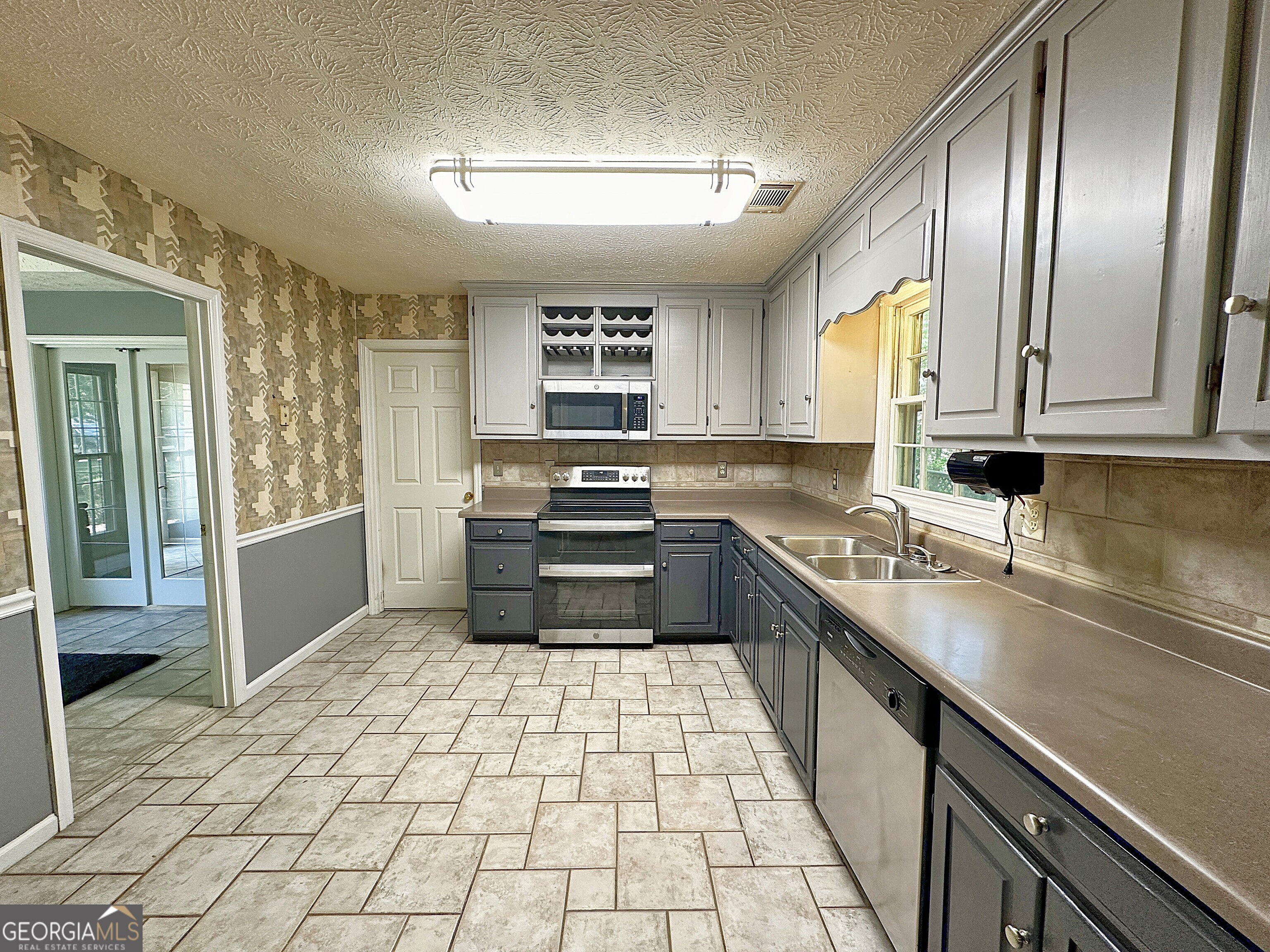 112 Greenbriar Trail LaGrange, GA 30241 - Photo 11 of 29 a kitchen with stainless steel appliances granite countertop a sink stove and cabinets