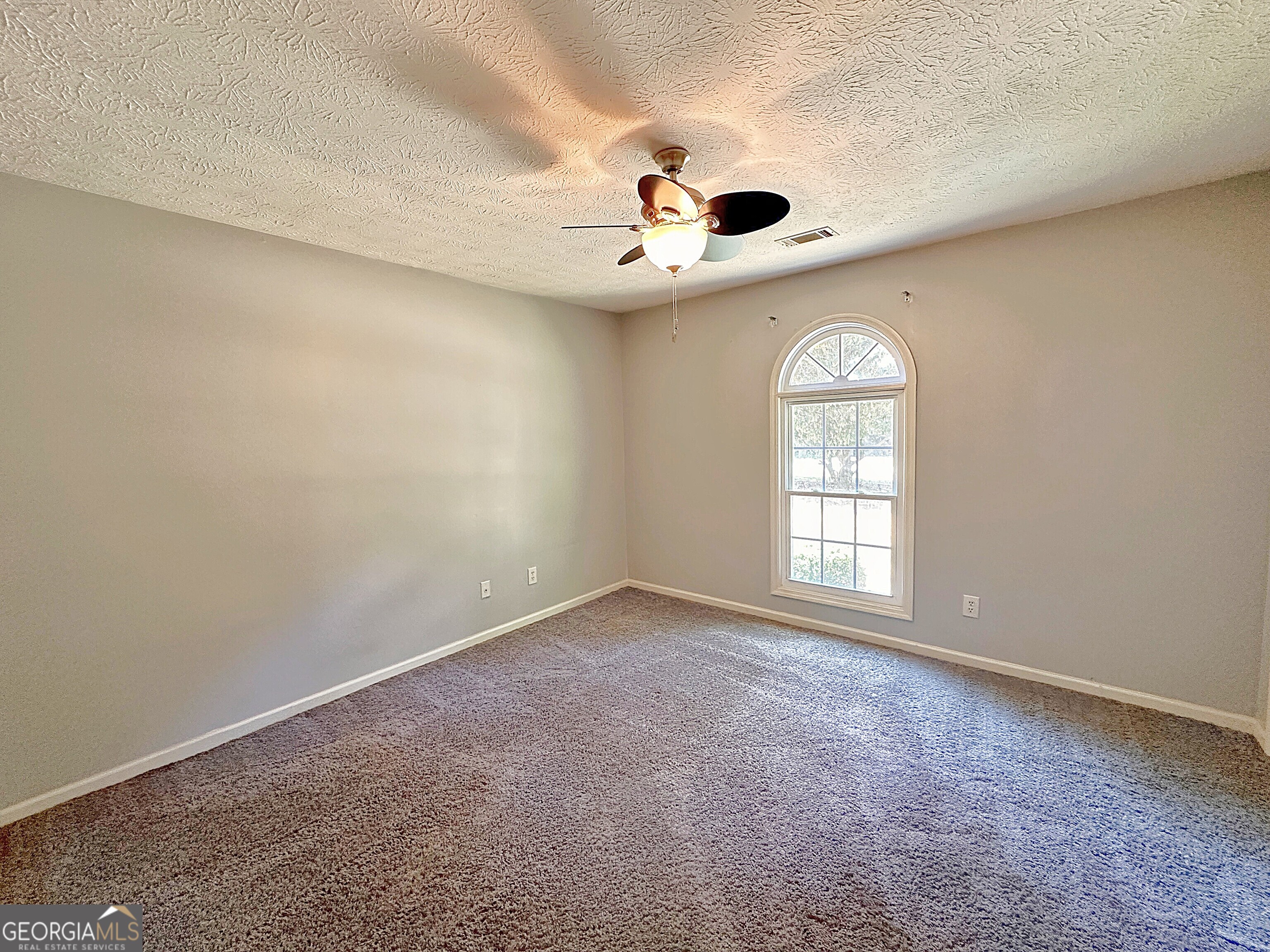112 Greenbriar Trail LaGrange, GA 30241 - Photo 19 of 29 an empty room with a window and a ceiling fan