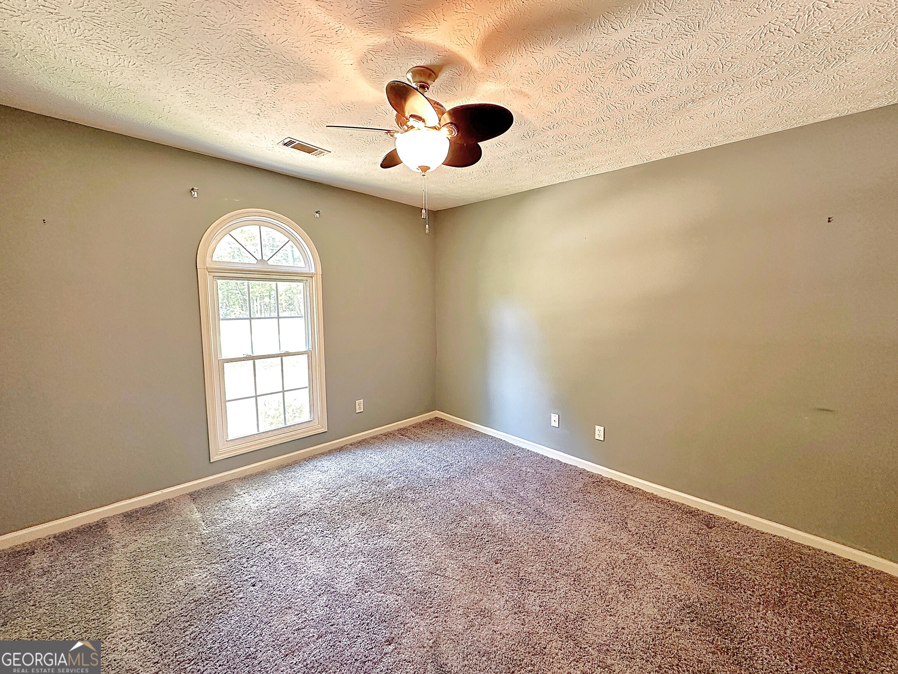 112 Greenbriar Trail LaGrange, GA 30241 - Photo 22 of 29 an empty room with a window and a ceiling fan
