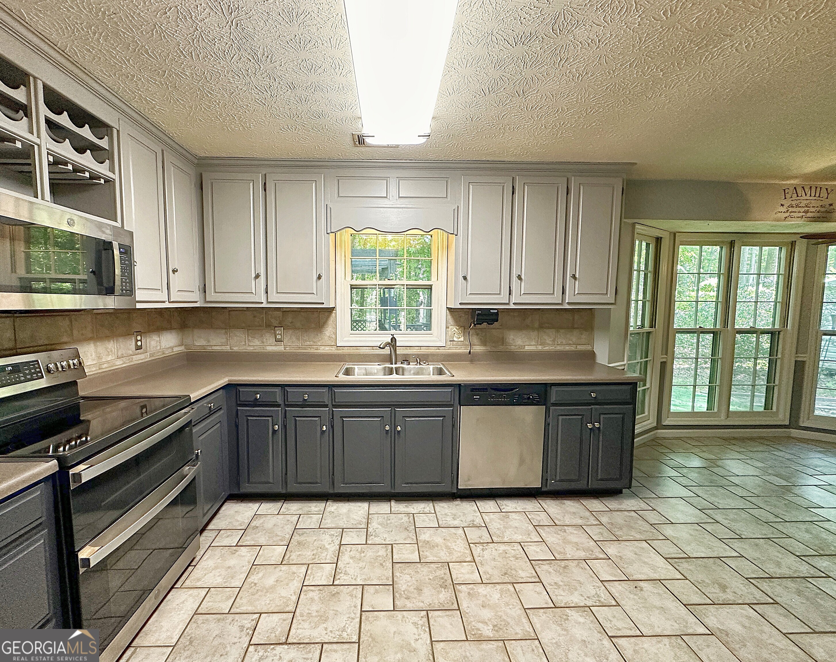 112 Greenbriar Trail LaGrange, GA 30241 - Photo 10 of 29 a kitchen with granite countertop a stove a sink and a microwave