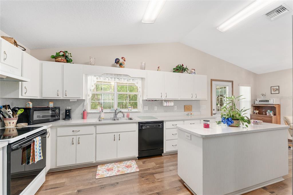 12681 Southeast 54th Avenue Belleview, FL 34420 - Photo 13 of 46 a kitchen with a sink stove and cabinets
