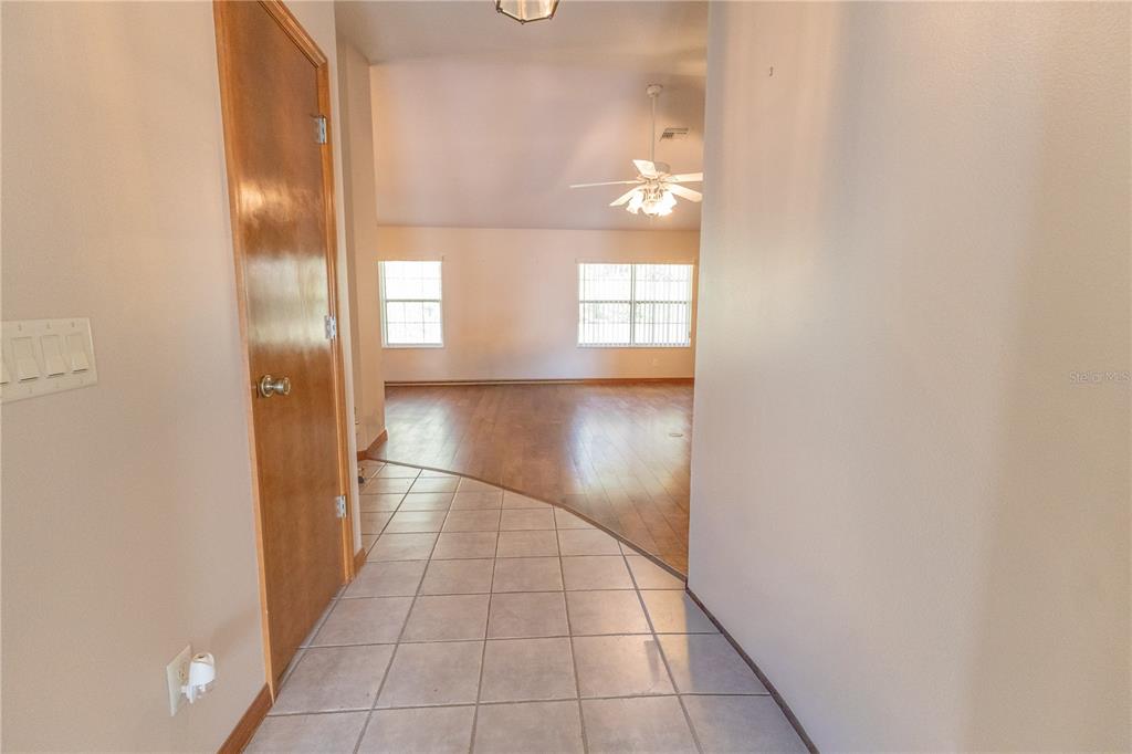 12681 Southeast 54th Avenue Belleview, FL 34420 - Photo 15 of 46 an entryway with wooden floor mirror and windows