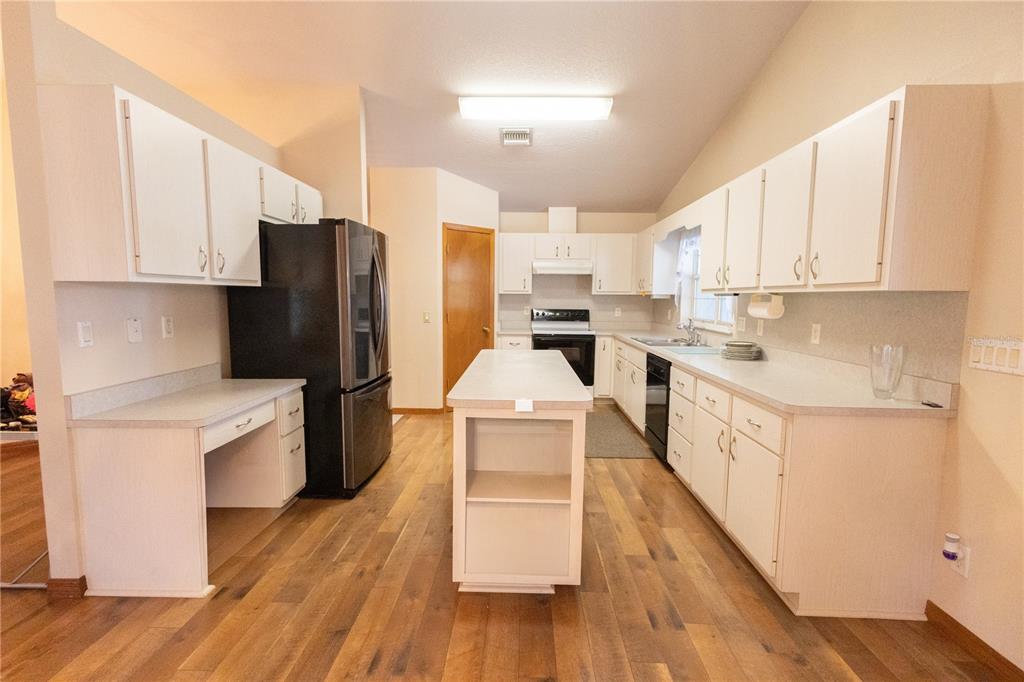 12681 Southeast 54th Avenue Belleview, FL 34420 - Photo 18 of 46 a kitchen with stainless steel appliances a refrigerator sink and cabinets