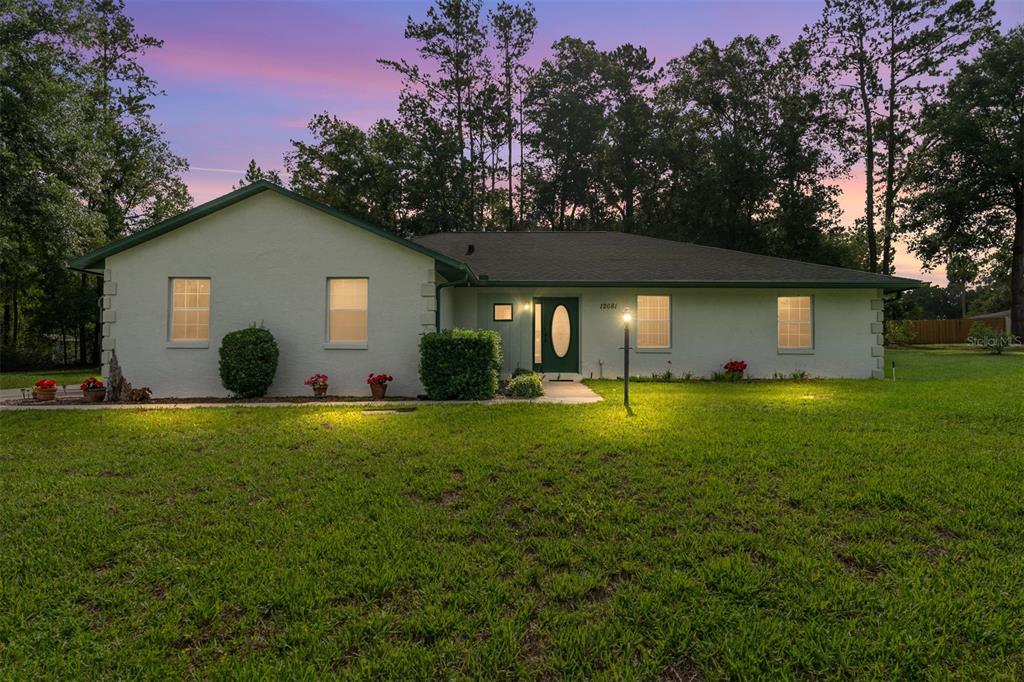 12681 Southeast 54th Avenue Belleview, FL 34420 - Photo 2 of 46 a front view of house with yard and green space