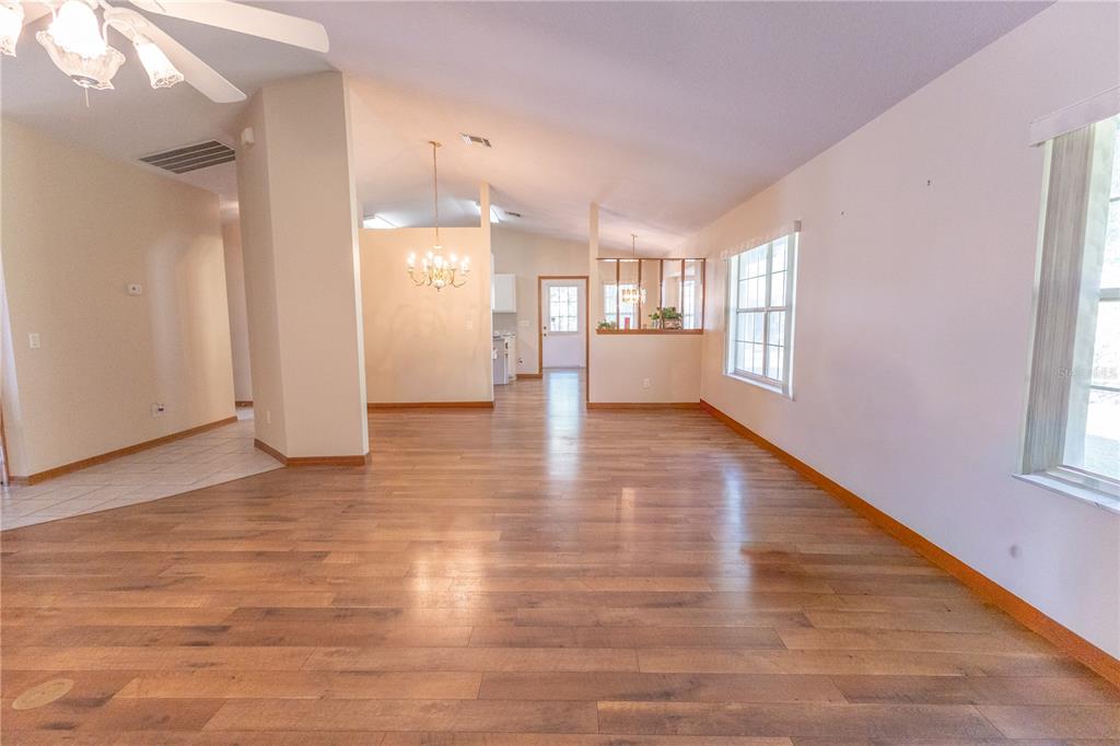 12681 Southeast 54th Avenue Belleview, FL 34420 - Photo 24 of 46 a view of an empty room with window and wooden floor