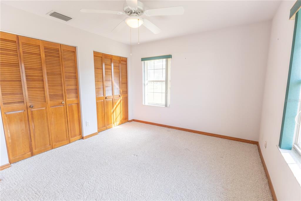 12681 Southeast 54th Avenue Belleview, FL 34420 - Photo 32 of 46 an empty room with windows and fan