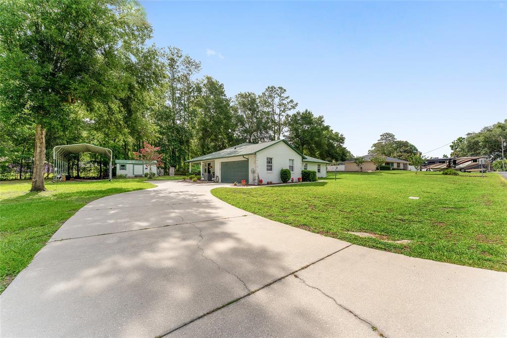 12681 Southeast 54th Avenue Belleview, FL 34420 - Photo 5 of 46 a front view of house with yard and green space