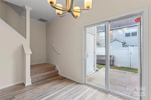 a view of a hallway view with wooden floor and staircase