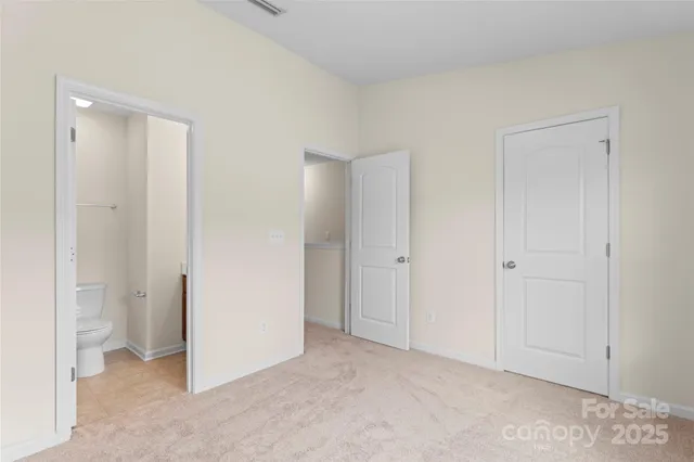 a view of an empty room and closet area