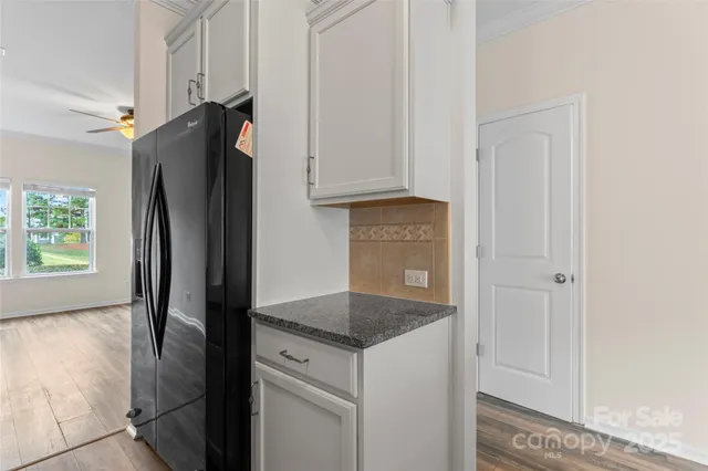 a kitchen with stainless steel appliances granite countertop a refrigerator and a stove