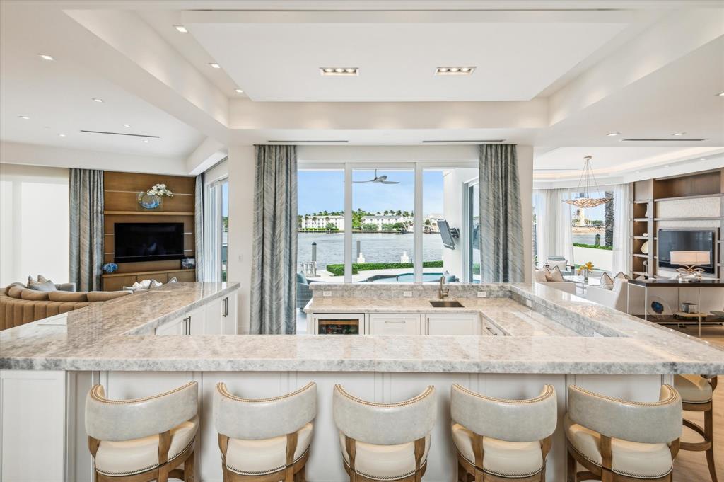 2400 Bay Drive Pompano Beach, FL 33062 - Photo 12 of 55 a kitchen with granite countertop and chairs