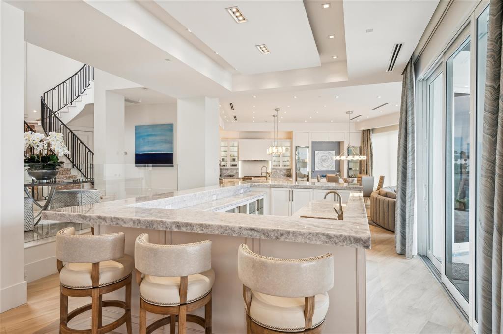 2400 Bay Drive Pompano Beach, FL 33062 - Photo 13 of 55 a kitchen with stainless steel appliances granite countertop a sink and a refrigerator