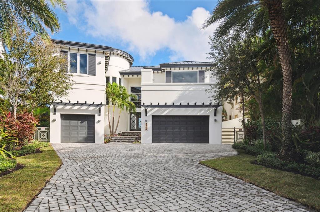 2400 Bay Drive Pompano Beach, FL 33062 - Photo 23 of 55 a front view of a house with yard and garage