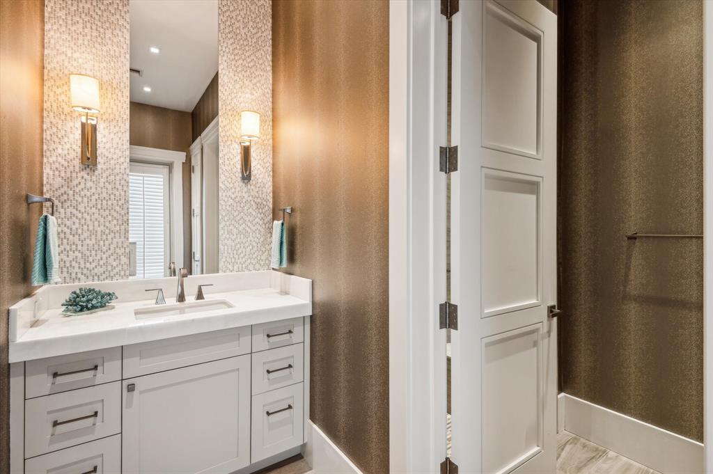 2400 Bay Drive Pompano Beach, FL 33062 - Photo 31 of 55 a bathroom with a double vanity sink and a mirror