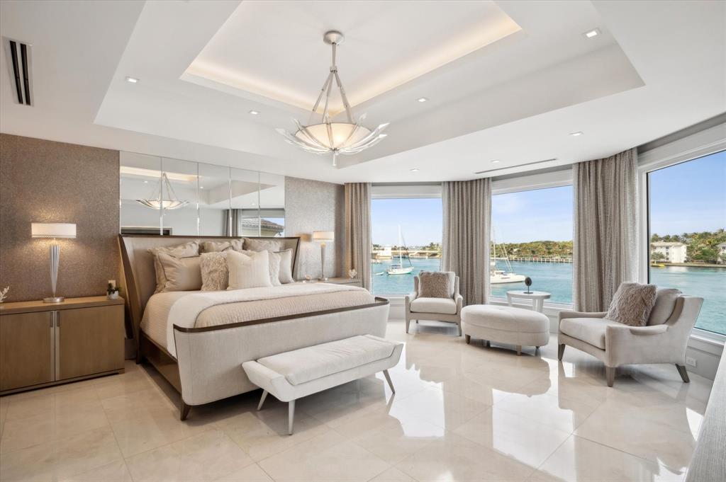 2400 Bay Drive Pompano Beach, FL 33062 - Photo 36 of 55 a spacious bedroom with a bed and glass walk in closet