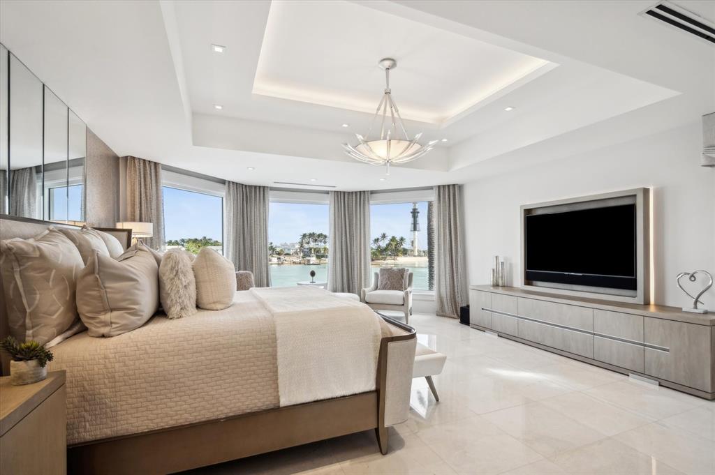 2400 Bay Drive Pompano Beach, FL 33062 - Photo 37 of 55 a spacious bedroom with a bed and a flat screen tv