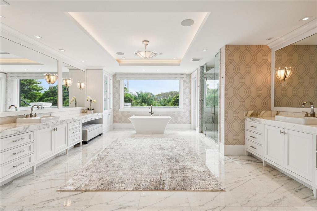 2400 Bay Drive Pompano Beach, FL 33062 - Photo 38 of 55 a large bathroom with a double vanity sink a mirror and a bathtub