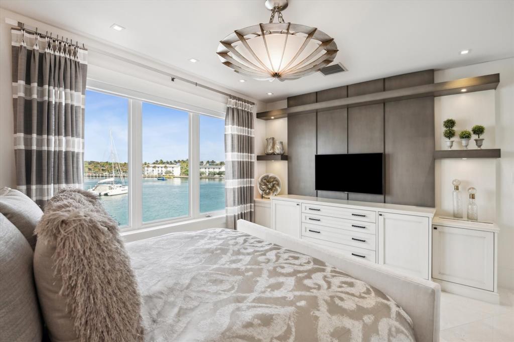 2400 Bay Drive Pompano Beach, FL 33062 - Photo 44 of 55 a bedroom with a bed and a flat screen tv