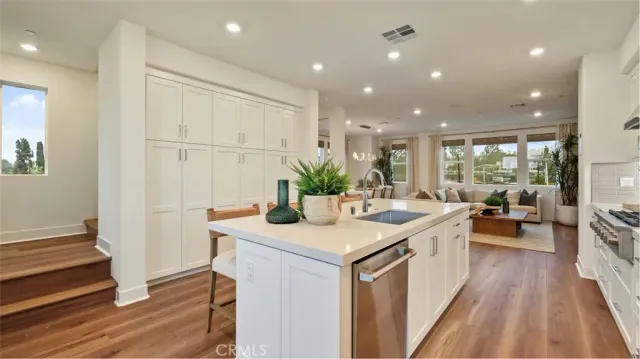 a kitchen with sink stove and refrigerator