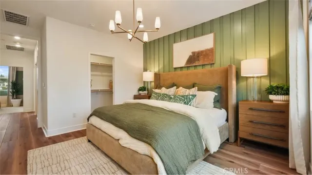 a spacious bedroom with a bed and a dresser