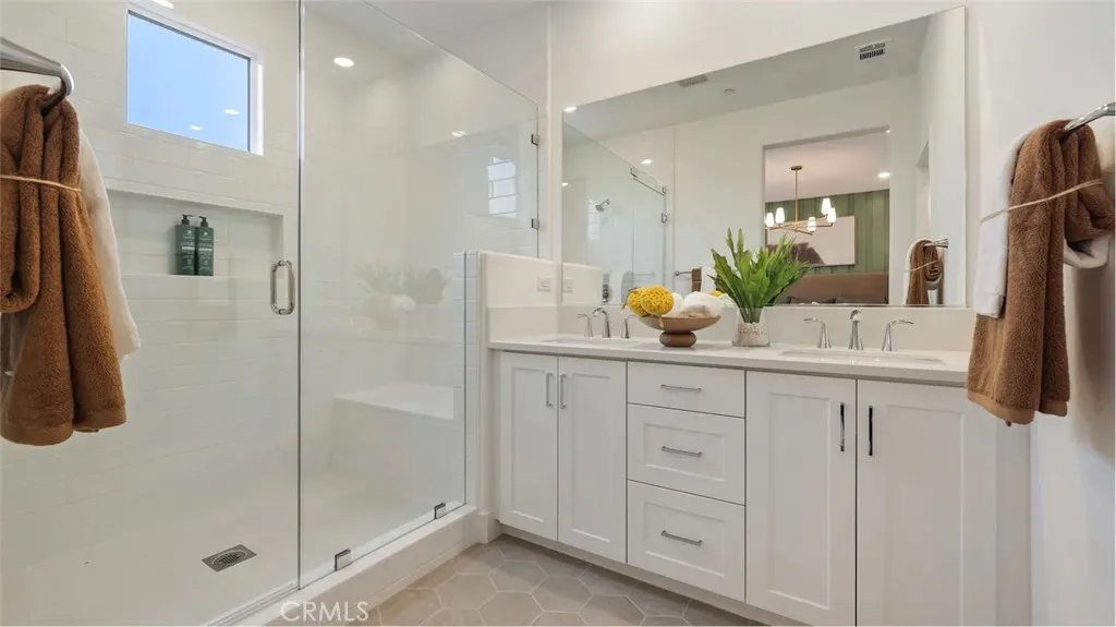 1803 Lychee Street Fullerton, CA 92835 - Photo 14 of 23 a bathroom with a granite countertop sink a mirror a shower and vanity