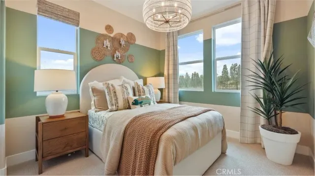 a bedroom with a bed and a chandelier