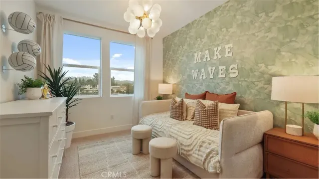 a bedroom with a bed and a potted plant on the dresser