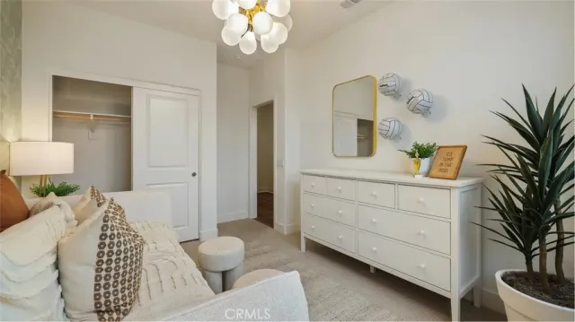 a bedroom with a large bed and ceiling fan