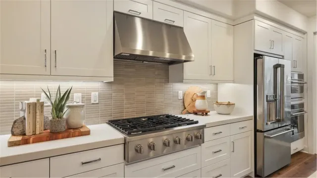 a kitchen with granite countertop a stove and a refrigerator