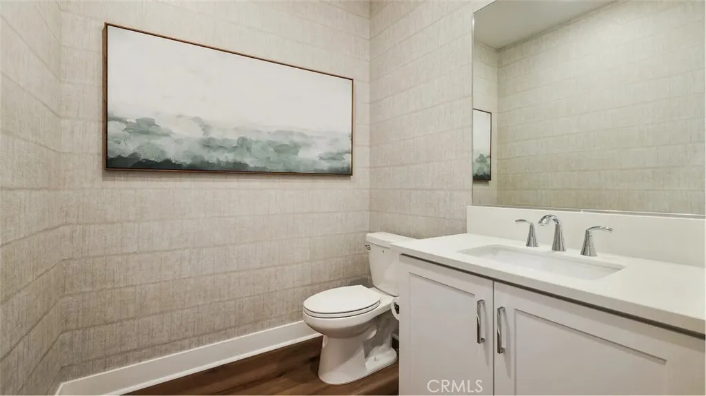 1803 Lychee Street Fullerton, CA 92835 - Photo 10 of 23 a bathroom with a toilet a sink and mirror