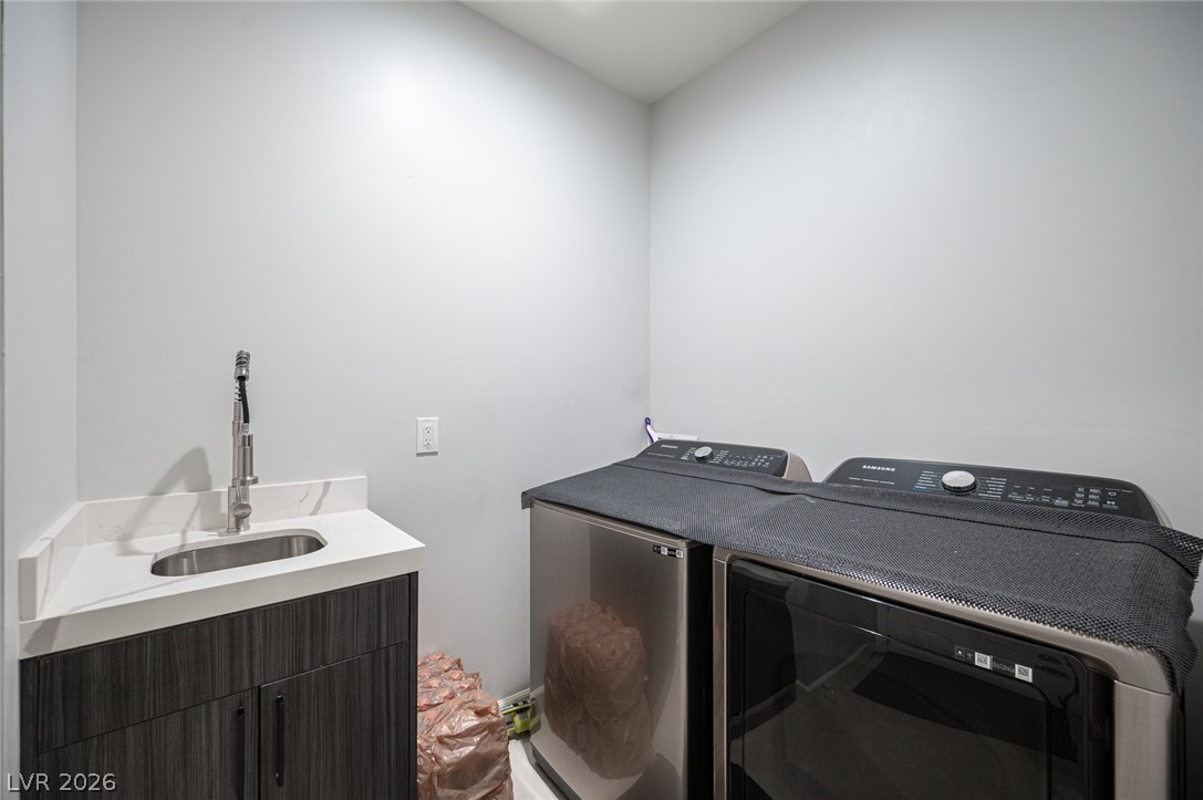 441 Belville Road Pahrump, NV 89048 - Photo 40 of 44 A dedicated laundry room provides convenience with a utility sink and modern appliances.