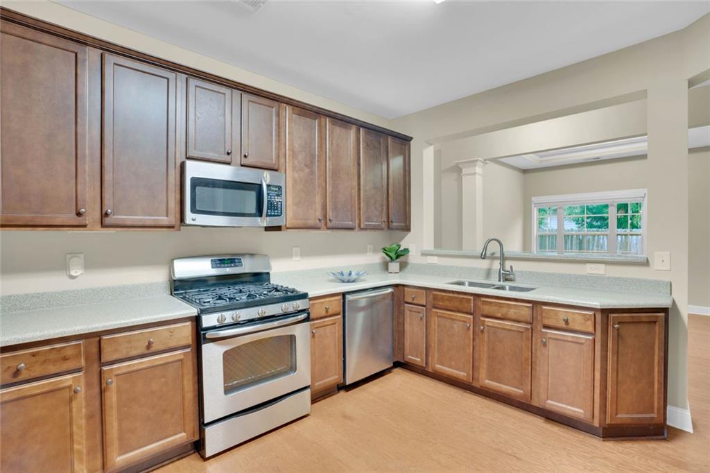 960 Verlander Trail Mableton, GA 30126 - Photo 16 of 30 a kitchen with sink a microwave and cabinets