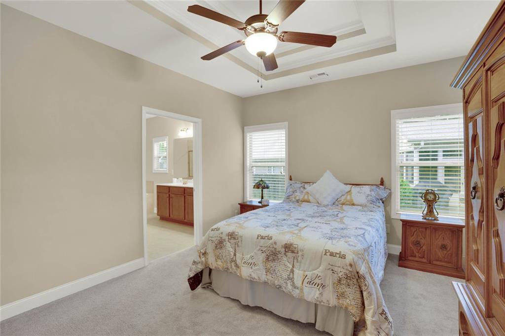 960 Verlander Trail Mableton, GA 30126 - Photo 4 of 30 a spacious bedroom with a bed and a chandelier