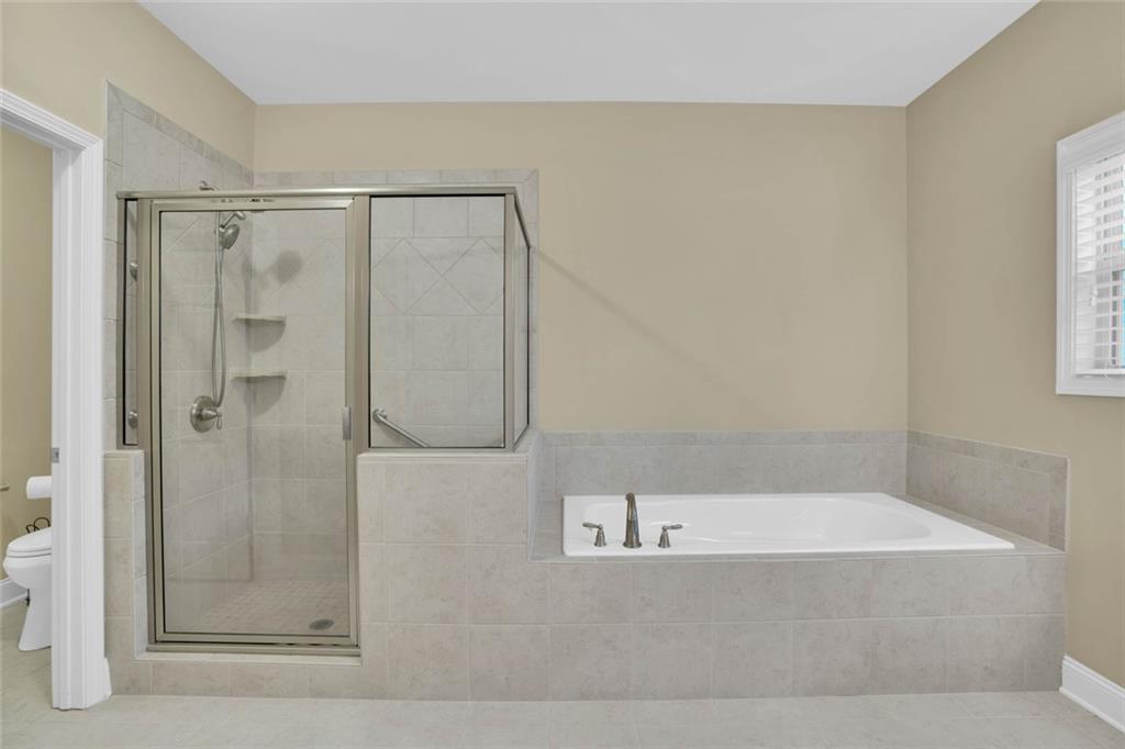960 Verlander Trail Mableton, GA 30126 - Photo 7 of 30 a bathroom with a bathtub and a shower