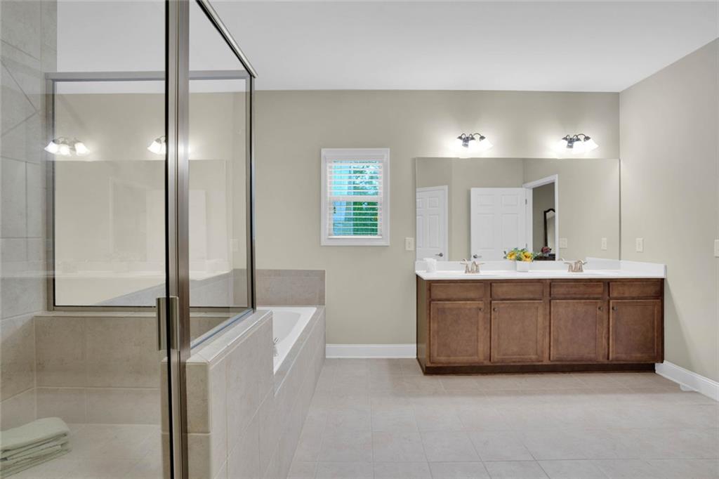 960 Verlander Trail Mableton, GA 30126 - Photo 8 of 30 a bathroom with a double vanity sink and mirror