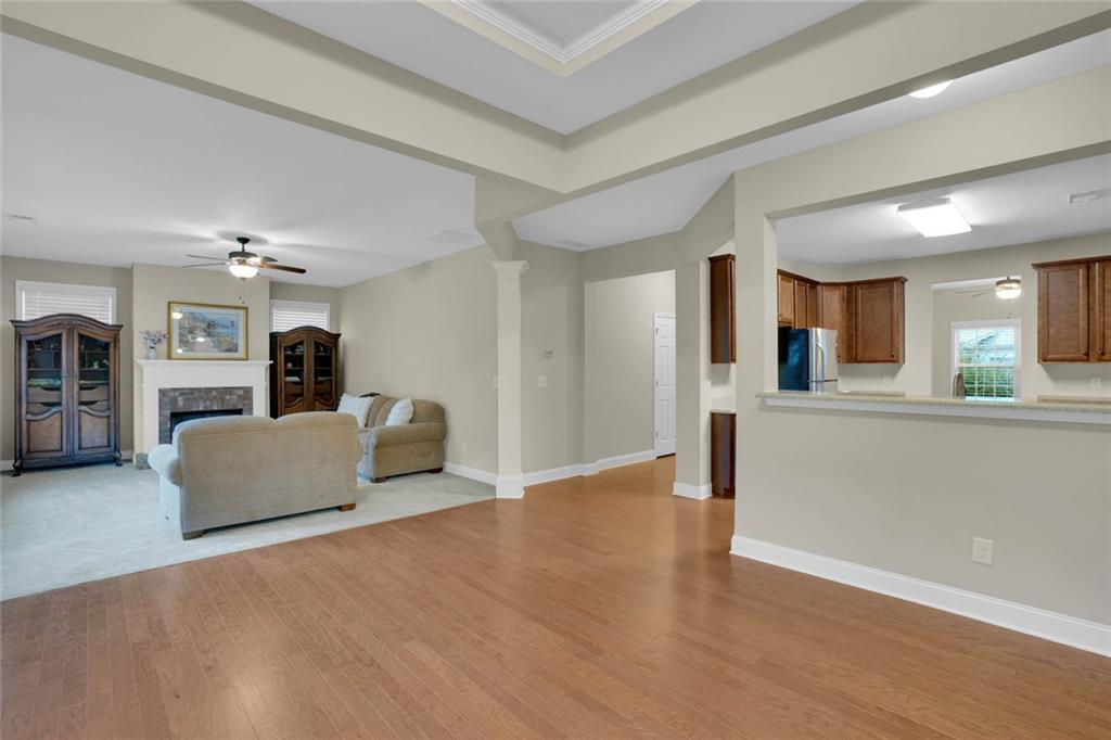 960 Verlander Trail Mableton, GA 30126 - Photo 9 of 30 a view of an empty room and kitchen with furniture wooden floor and a window