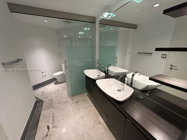 200 Biscayne Blvd Way, Unit 701 Miami, FL 33131 - Photo 12 of 12 a view of a bathroom with a toilet sink and mirror