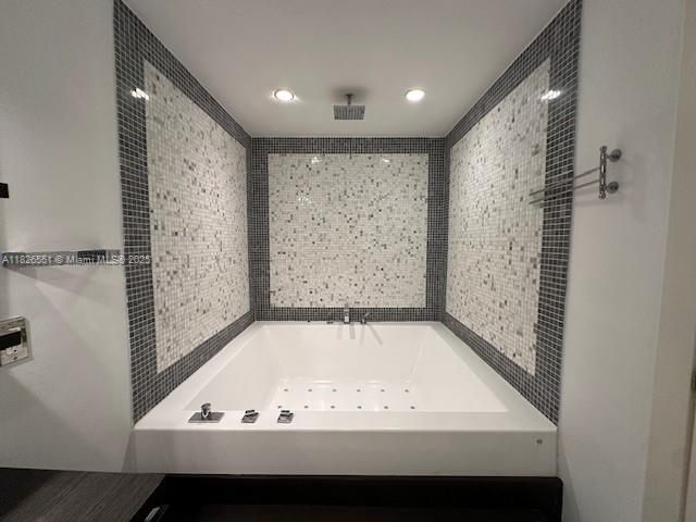 200 Biscayne Blvd Way, Unit 701 Miami, FL 33131 - Photo 10 of 12 a bathroom with a bathtub and a shower