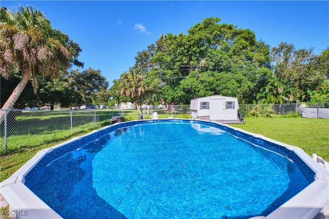 a view of a swimming pool with a backyard