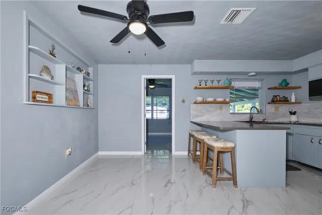 a kitchen with granite countertop cabinets a sink and stainless steel appliances