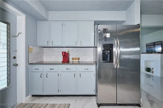 a kitchen with cabinets and stainless steel appliances
